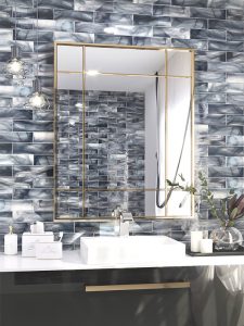 gorgeous blue tiles in bathroom behind vanity mirror