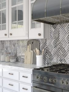 marble arrow pattern backsplash tile in kitchen