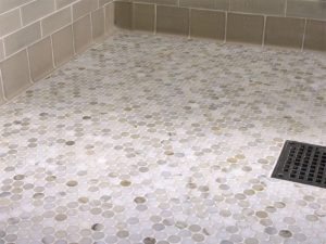 Calacatta gold marble penny round tiles on floor 